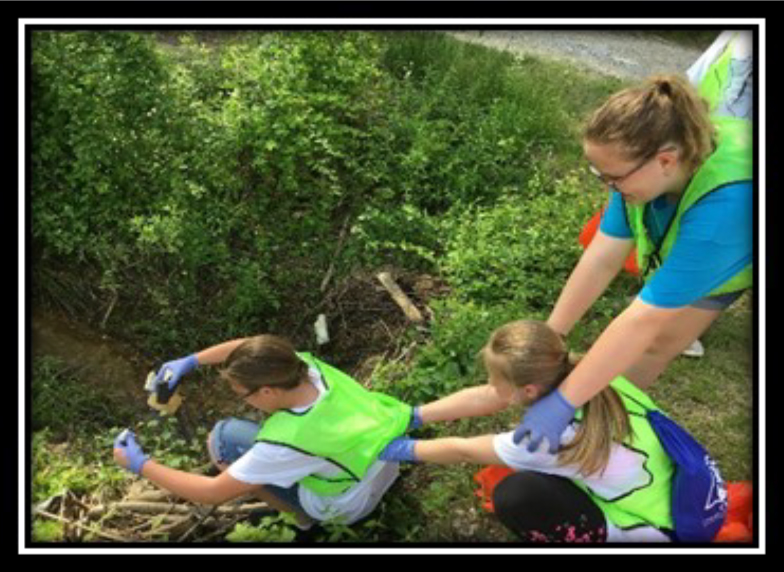 4-H Day Of Service Scott County- Cleaning up garbage near a creek.