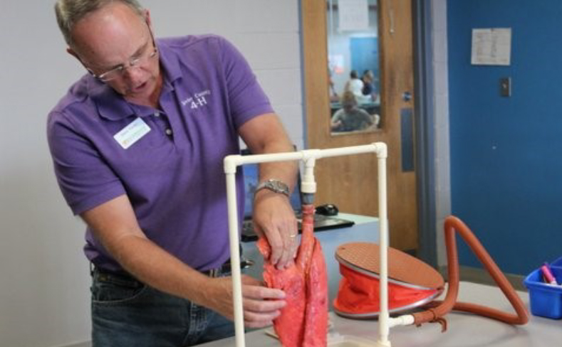 4-H Health Rocks! Produces Positive Results - 4-H leader helping with project