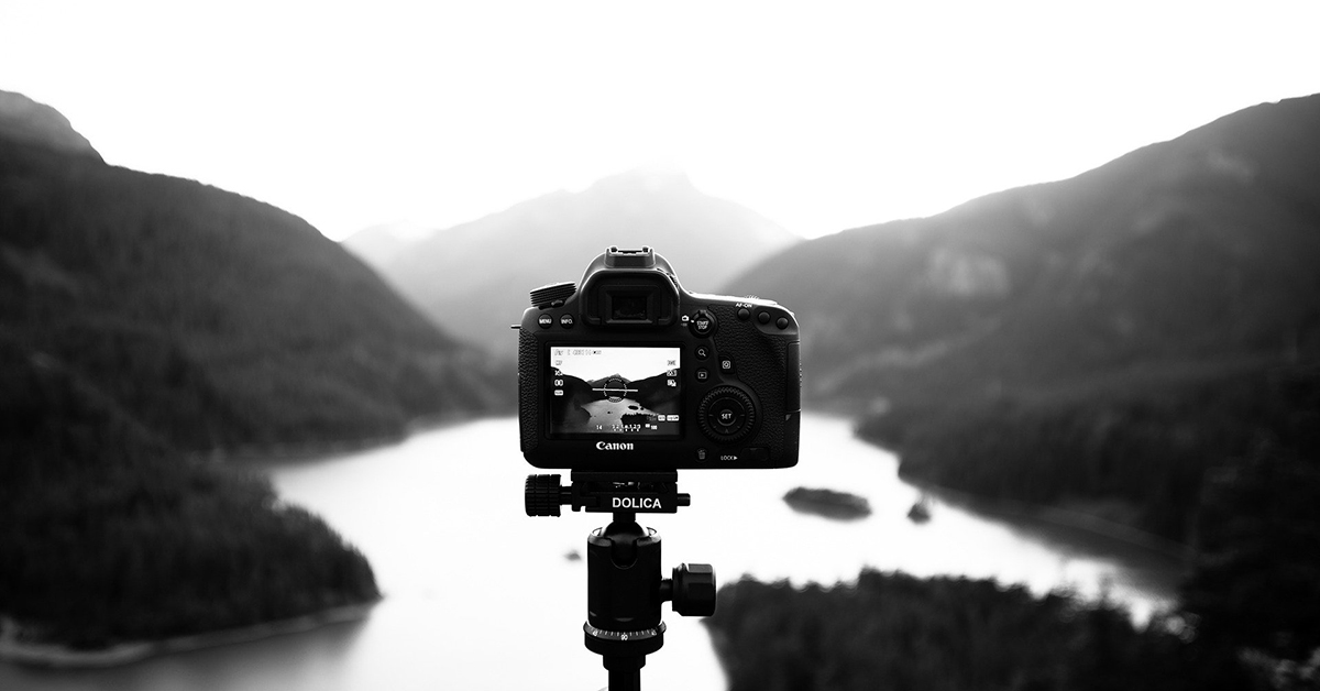 Photo Search - Camera looking over mountains and lake.