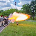 2017 Photo Search - Men dressed in civil war attire firing a cannon.