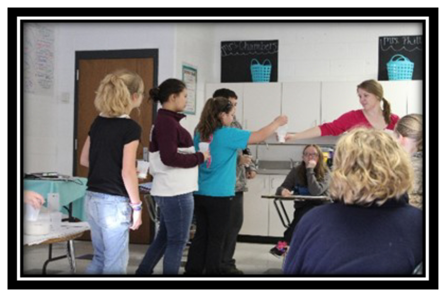 Walmart Grant Projects - Students have measured how much sugar is in different snacks or drinks from a daily menu. The class is adding up how much sugar Mrs. Emily consumed that day.