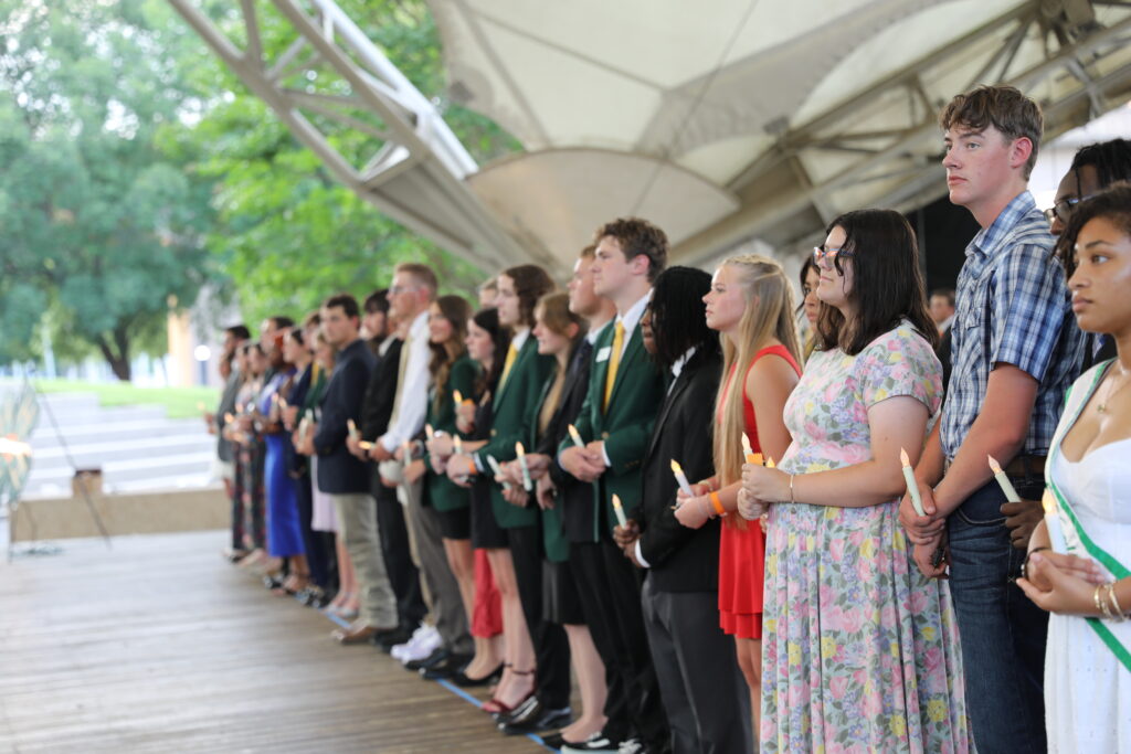 Vol State recipients in a line holding candles.