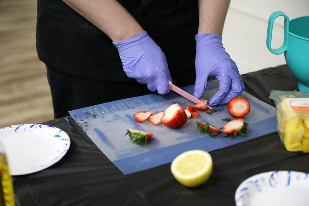 closeup of strawberries being chopped.